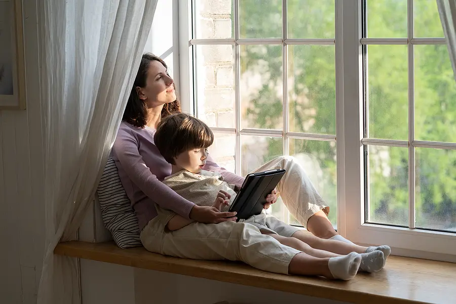 Son and mother sitting after a window replacement.